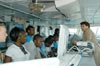 NOAA corps LTJG Jennifer Pralgo introducing students to the bridge