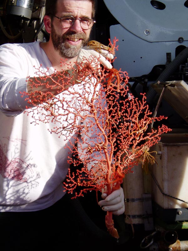 Scott France holds up a deep sea coral