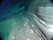 Interlayered basaltic (dark) and felsic (light) ash layers in the east wall of West Rota caldera. 