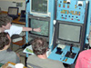 Team is gathered around the ROPOS console, identifying vent species on the seafloor.