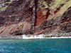 The vertical column in the center of the image, called a dike, rises from below sea level to the pinnacle at the top of the ridge.