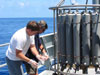 Geoff Lebon (foreground) and Ed Baker (background) are removing plume water from the CTD bottles after a tow-yo.