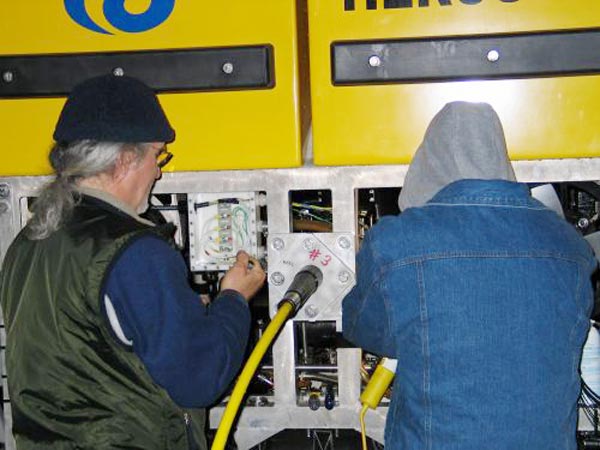 IFE ROV technicians/pilots work to disconnect the fiberoptic cable from Hercules.