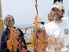 Holding a bushy black coral covered in mucus.