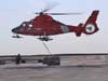 Vertical Replenishment (VERTREP) entails flying cargo nets full of equipment suspended below the helicopter.