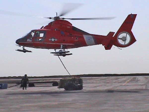 Vertical Replenishment (VERTREP) entails flying cargo nets full of equipment suspended below the helicopter.