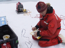 Mette Nielson measures the temperature of a recently-drilled ice core.