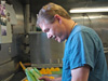 Head Cook, Ray Gideons, washes lettuce for the full salad bar that accompanies lunch and dinner on board.