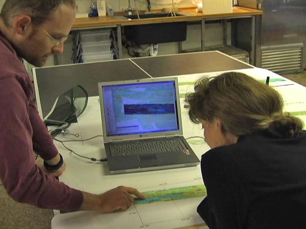 Scientist look at one of the higher resolution bathymetric maps created during the first week of the cruise.