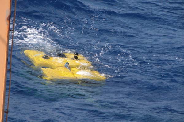 The ROV Hercules is oriented back to back with the ship while the ROV Argus is lifted in to the water.