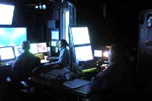 In the control van, Sarah L'Heureux of the Woods Hole Oceanographic Institution performs her data logger duties.