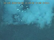 Liquid sulfur bubbling up from a pit at Daikoku volcano.