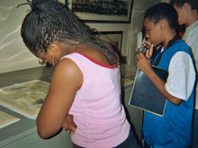 Nicole, Brandon and Joseph examine historic documents 