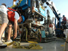 Immediately after pilot, Tito Collasius, lowers the Jason onto the aft deck of the NOAA Ship Ron Brown with the Effer crane, navigator, Brian Bingham, straps the ROV down to the deck.