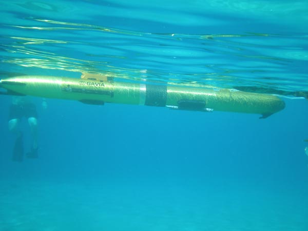 Floating gently just below the surface with only the communications tower above the surface, the Gavia AUV awaits another mission command.