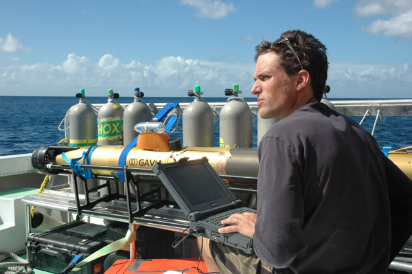 Conducting AUV operations from a boat, Alex tracks one of the Gavia AUVs using a heavy-duty computer. 