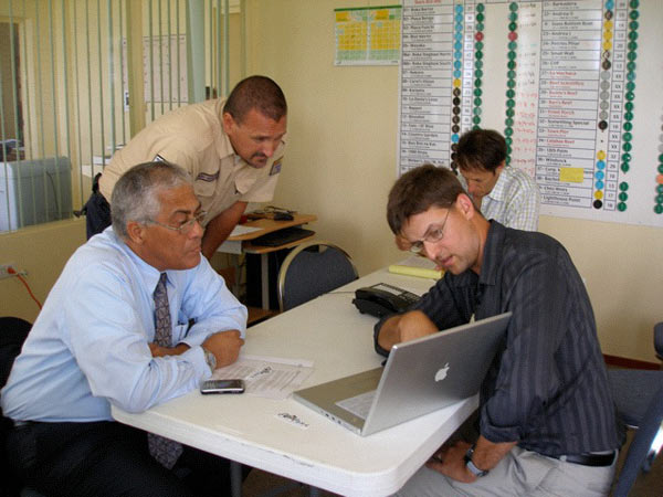 Bonaire island leaders and Bonaire's marine park manager listen as some of the preliminary findings from surveys are explained.