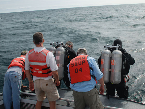 Divers Joe Hoyt and Russ Green prepare to dive the Middle Island Sinkhole assisted by Scott Kendall, Steve Nold and Tom Joyce.