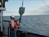 Scientist removes sediment sample from the gravity core for later analysis.