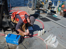 Tom Novell collects groundwater for future analysis. Samples will be analyzed for radium, chlorine, oxygen and hydrogen.