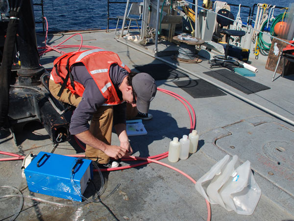 Tom Novell collects groundwater for future analysis. Samples will be analyzed for radium, chlorine, oxygen and hydrogen.