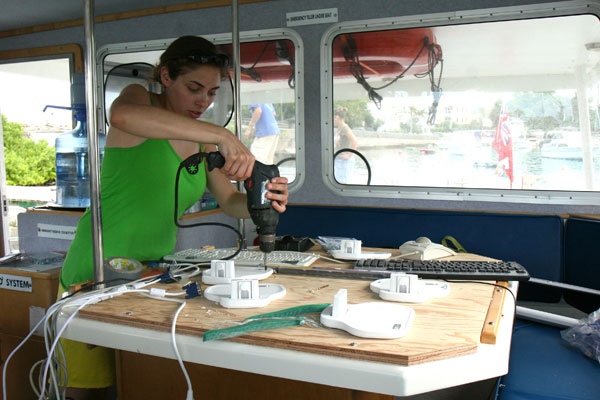 CSUMB Graduate Student Katie Glitz installs computer platforms on the scientific lab tables inside the Endurance.  