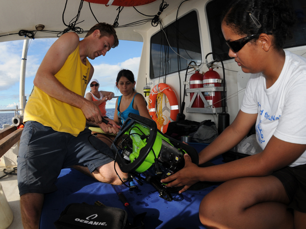 Todd Hallenbeck, Krystle Gomez and Alexis Hall, work together to prepare the ROV for launch and exploration.