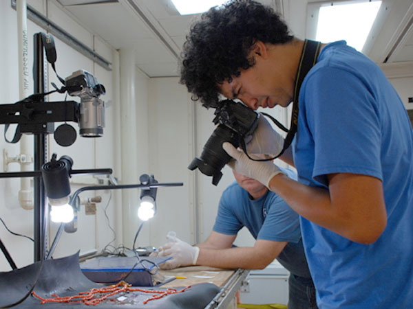 Santiago Herrera photographs a coral specimen.