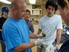 Dr. Tim Shank discusses a seafloor specimen with other members of the science party. 