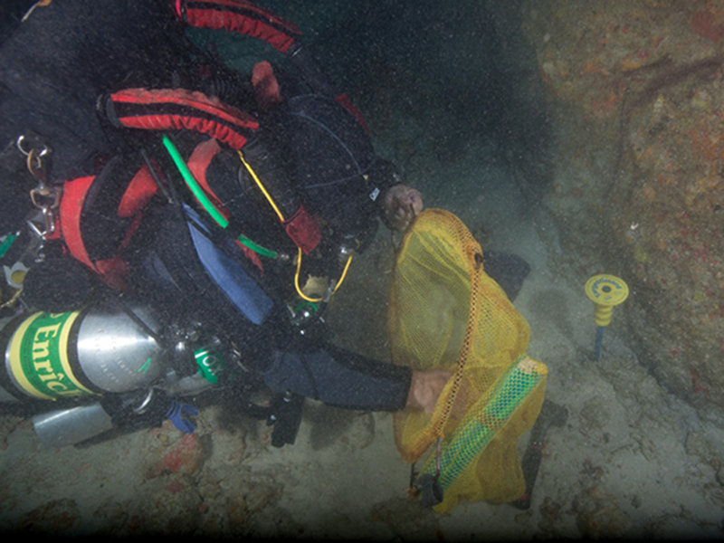 Paul Heinerth collecting geological samples at depth.