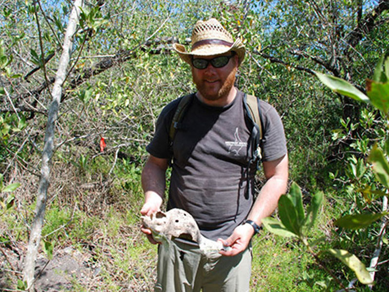 Derek Smith holds up one of the many mollusks found in and around middens at Vista Alegre. Further testing, however, will have to be conducted to determine the origin and age of the shell.