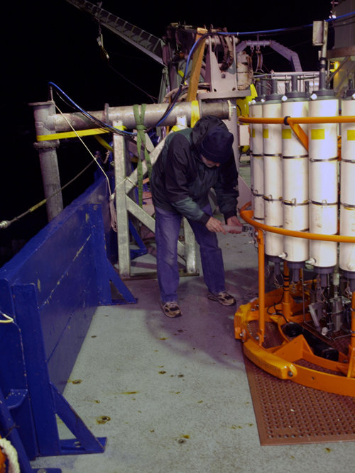 Marv collecting samples from the CTD-rosette using a plastic syringe. If there is methane in our seawater samples, Marv can tell us how much within just one to two hours of the samples coming back on deck. Right now, he is our secret weapon in tracking down the highly unusual vents we are pursuing.