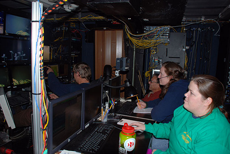 Graduate students Esprit Saucier, Alanna Casey, and NOAA Office of Ocean Exploration and Research archaeologist Frank Cantelas work with ROV Jason team to survey a World War I era shipwreck.