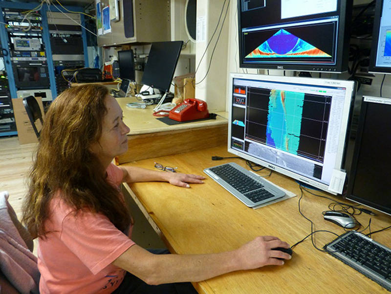 Susan Merle monitors the data collected by the ship’s multibeam sonar.