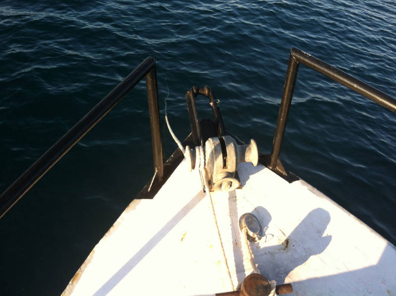 “On hook” during the early morning. The waters off Canaveral Seashore are considerably better than ours in St. Augustine in terms of visibility. Looking down the anchor line as it descends into the sea reminds us that our diving here will be accompanied by the ability to actually see what we are doing rather than having to do it by braille as is often the case in St. Augustine.