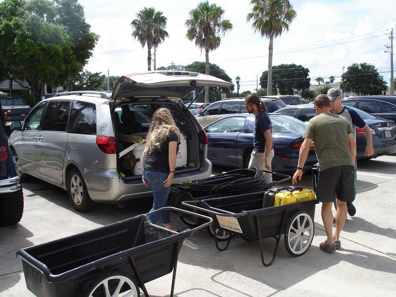 Dock carts are handy for moving lots of supplies from our vehicles to the boat. From left to right, Starr Cox, Brian McNamara, Brendan Burke, and Sam Turner.