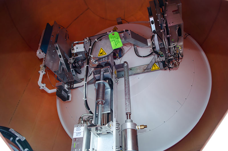 Inside one of the domes on the top deck is a satellite dish aimed at a satellite just above the horizon.