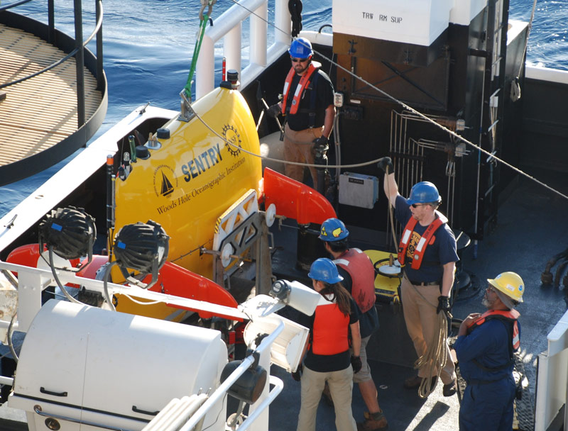 Carl (second from right) helps to prepare Sentry for deployment.