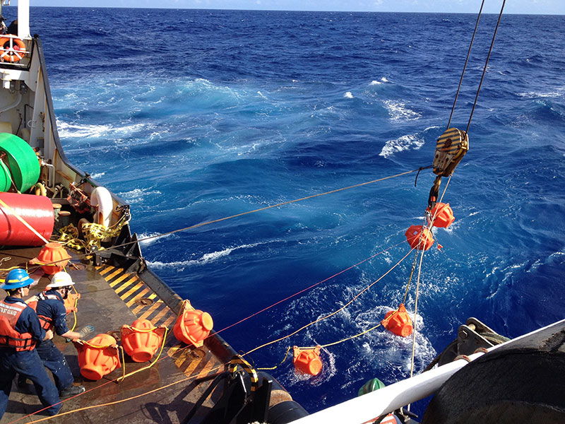 Petty Officer 2nd Class John Thompson, a boatswain's mate aboard the Coast Guard Cutter Sequoia, and Dr. Joseph Haxel, oceanographer with NOAA and Oregon State University, prepare special floats used to deploy a hydrophone in Challenger Deep near the Federated States of Micronesia, January 11, 2015. The crew of the Sequoia and NOAA scientists deployed the hydrophone in an attempt to listen to ambient sound in the deepest part of the Challenger Deep.