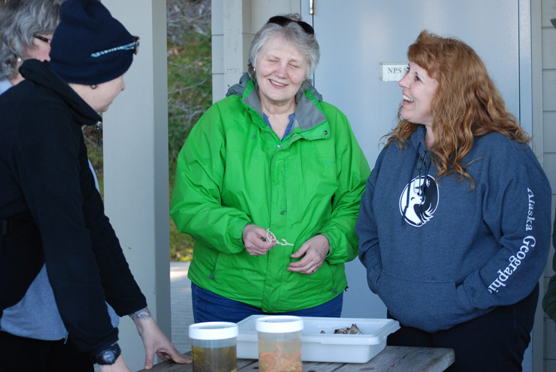 Amanda Kelley, left, talks to two visitors during the inport open house at Bartlett Cove.