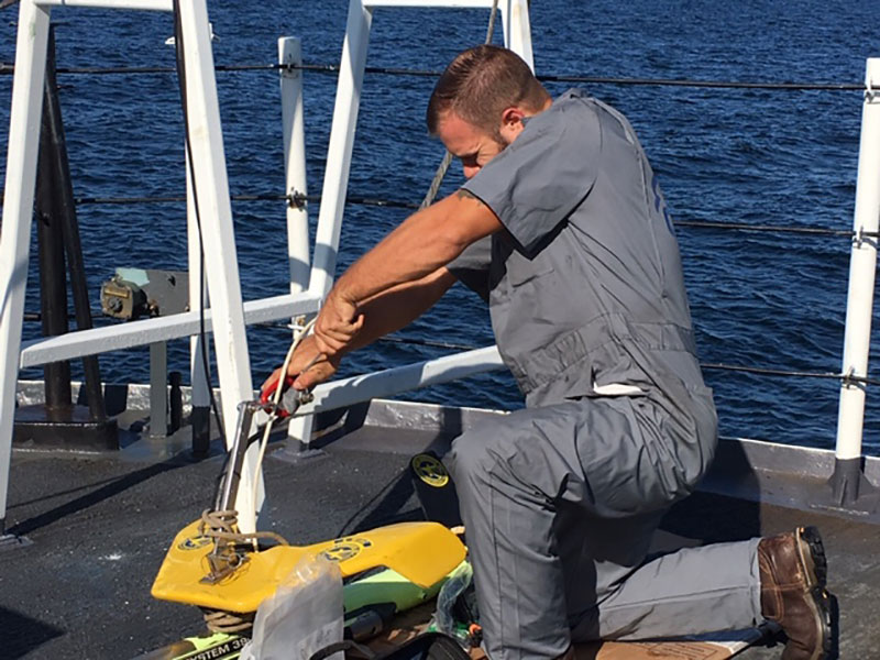 John Bright makes needed modifications to the sidescan instrument.