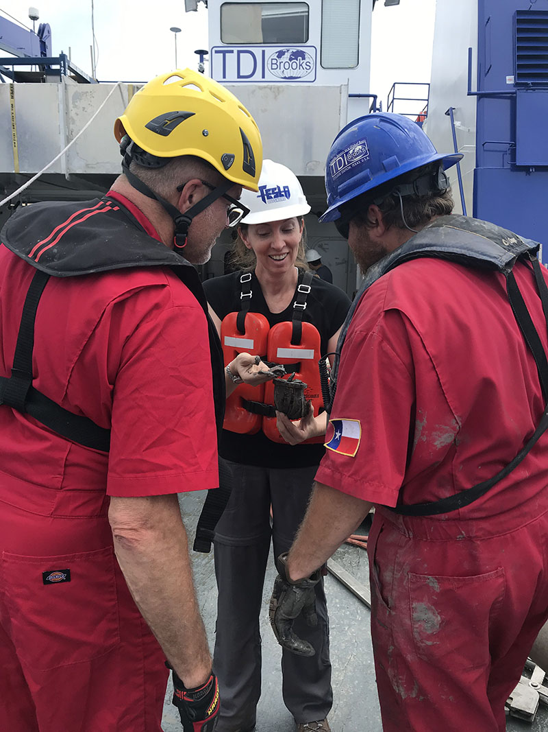 Dr. Amanda Evans excitedly showing the party chief and crew exciting finds.