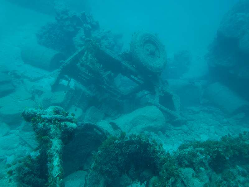 A World War II-era jeep trailer loaded with vehicle parts and equipment see off Agat Beach.