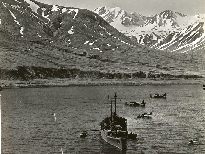 USS Casco anchored in Casco Bay, Attu surrounded by seaplanes at mooring (1943).