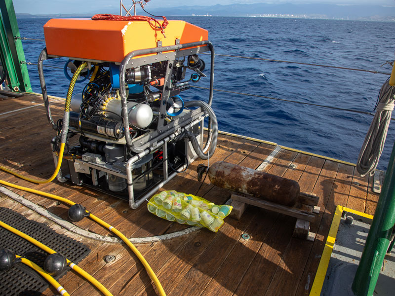 Styrofoam cups decorated by teens from the Boys & Girls Clubs of St. Lucie County bagged and attached to the remotely operated vehicle prior to a dive.