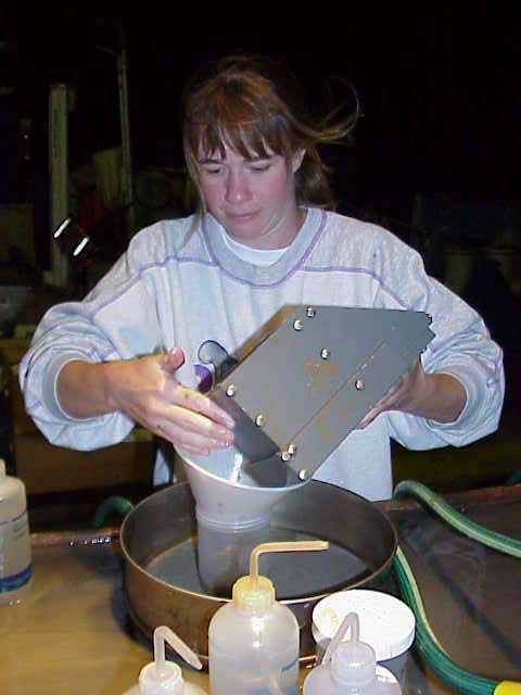 Tanya Podchaski seiving through a mud subcore