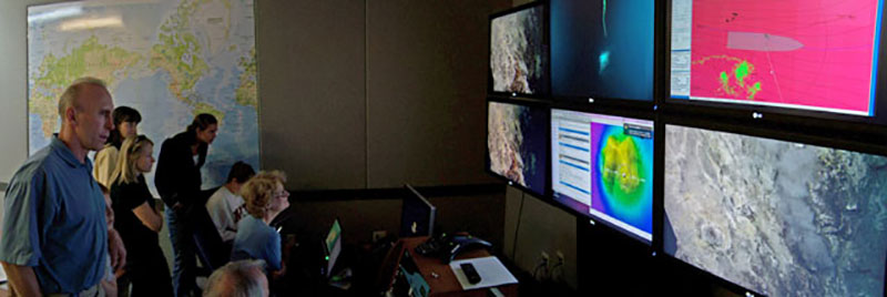 Participants marvel at imagery sent from the bottom of the Indonesian Sea to monitors at the Seattle ECC.