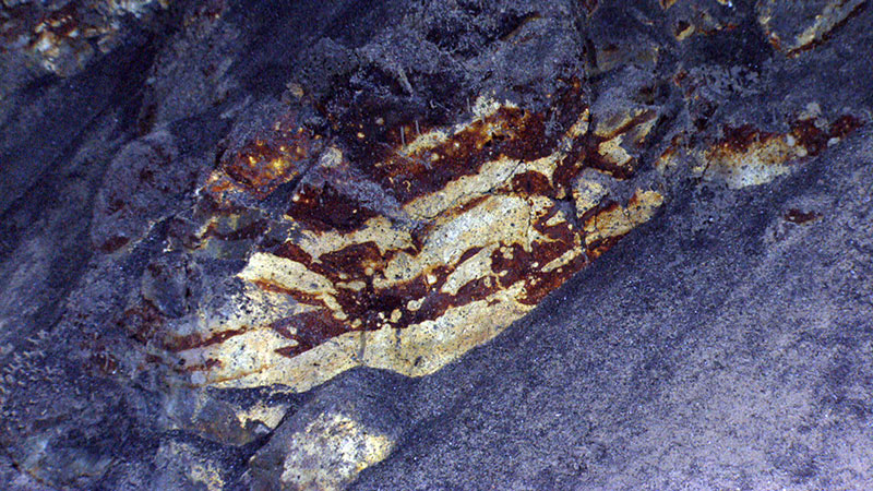 Rocky outcrops standing above the sediment like you see here contain brightly colored areas, altered from past hydrothermal activity.