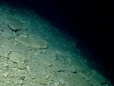 Debris material of various sizes and shapes accumulated in a debris apron at the base of a wall in Block Canyon.