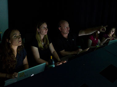 Telepresence provides many opportunities, including training the next generation of scientists. Here, Tim Shank, Co-science team lead for this cruise, and several of his students join the expedition from the Inner Space Center.